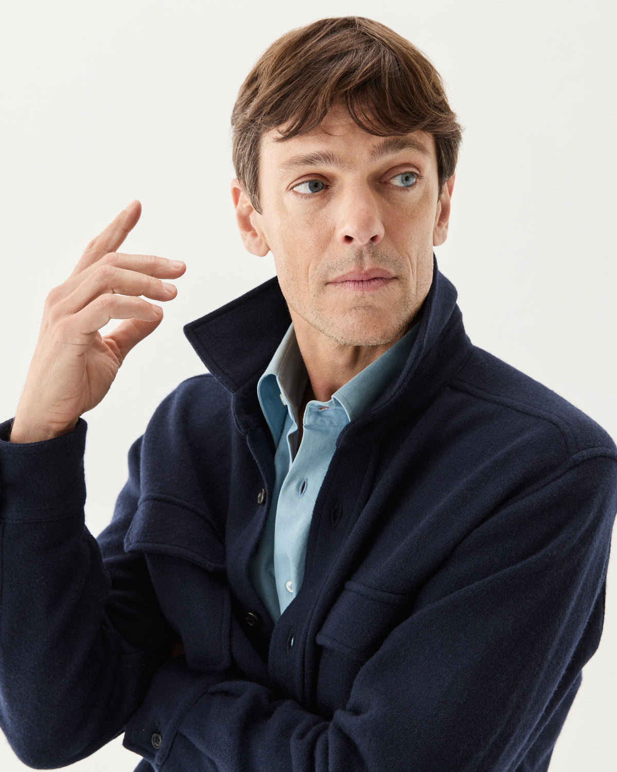 Knitted Wool Overshirt Navy, worn over a light blue shirt, close-up