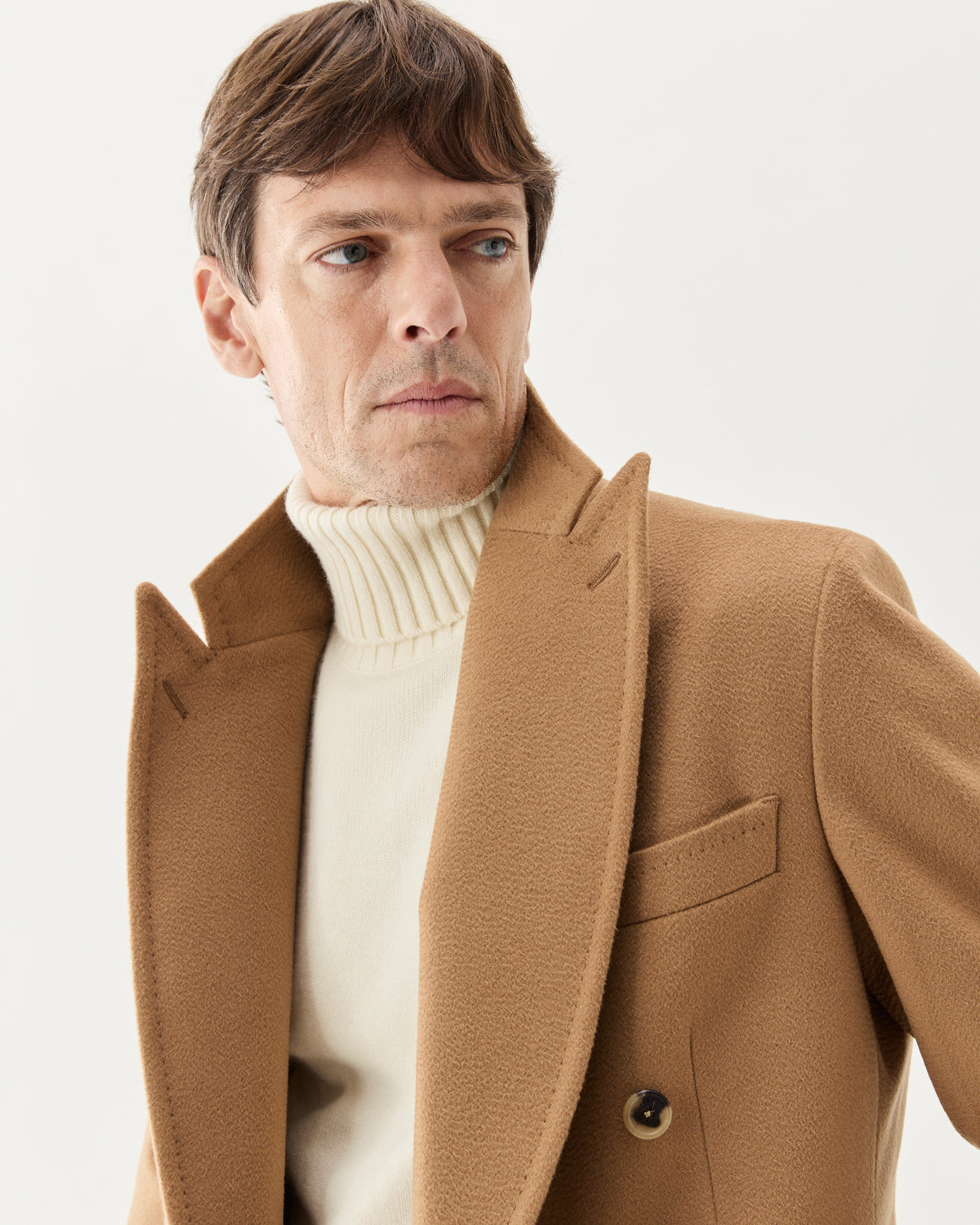 Double Breasted Cashmere Coat Camel, worn over a white turtleneck, peak lapels close-up